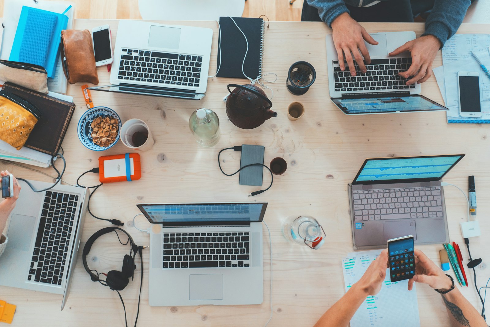 Startup team building on laptops — PLG launch context